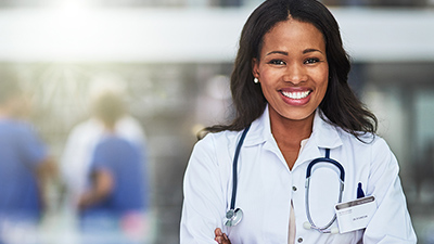 a smiling doctor crosses her arms 