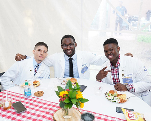 a group of men sit at a table