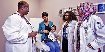 a doctor meets with patients in an office