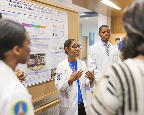 a woman presents her study at a Gloster Research event