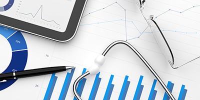 charts and graphs under a stethoscope 