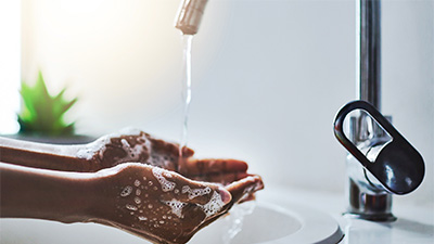 hands washing under a running faucet